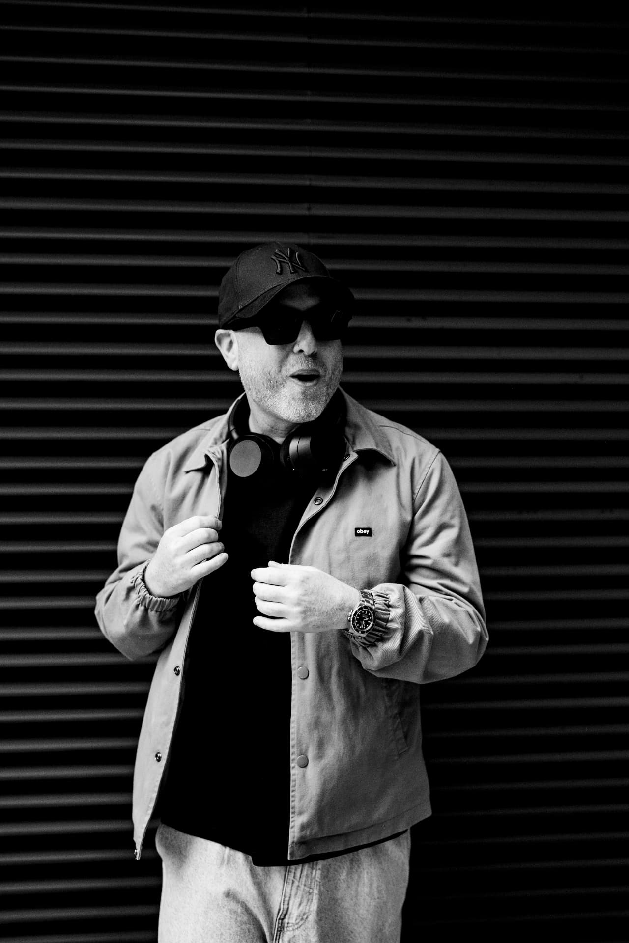 Biblical Beats against a black shutter, black and white